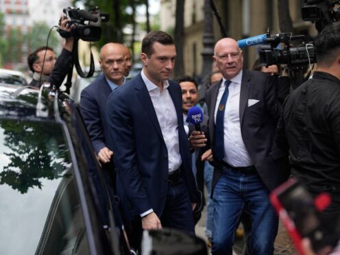 Jordan Bardella, centre left, president of the far-right National Rally party, arrives at the party headquarters in Paris (Thibault Camus/AP)