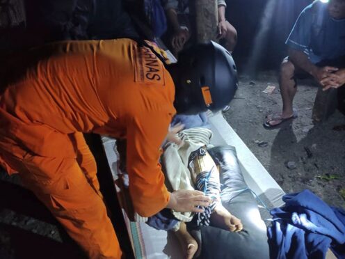 A injured victim of a landslide is attended to in Suwawa (BASARNAS via AP)