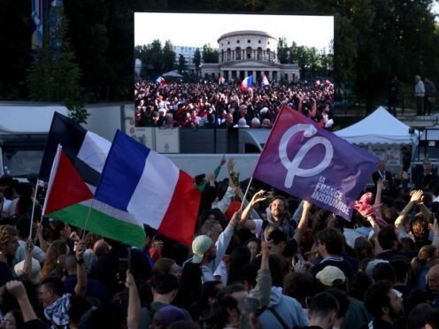 Supporters of the far-left La France Insoumise – LFI – (France Unbowed) party wave flags on Sunday (Thomas Padilla/AP)