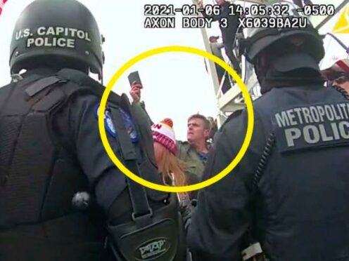 Jay Johnston, circled, has pleaded guilty to interfering with police officers trying to protect the US Capitol from a mob’s attack (Justice Department via AP, File)