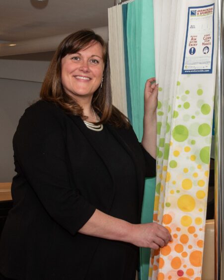 Hannah Evans shows off hospital curtains made by Bio Technics.