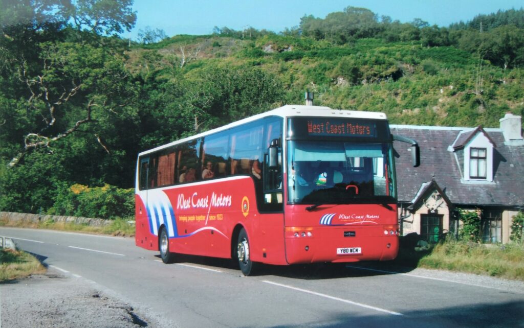 Bought in 2003 as the 80th anniversary coach, this DAF carries an appropriate registration mark. It's on private hire duty passing Erines on the A83 near Tarbert.