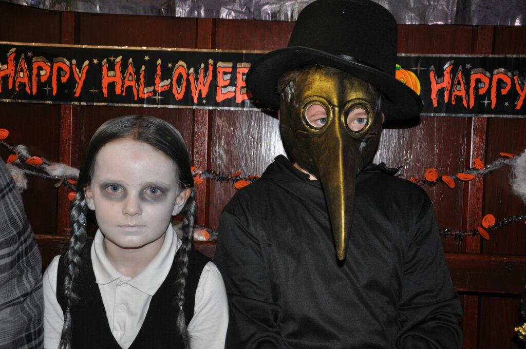 Wednesday Addams and a plague doctor at the Shiskine party.