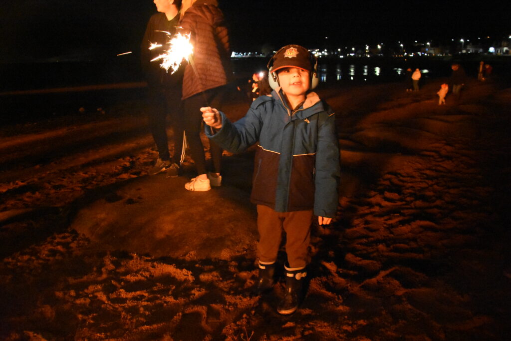 One young lad with a sparkler.