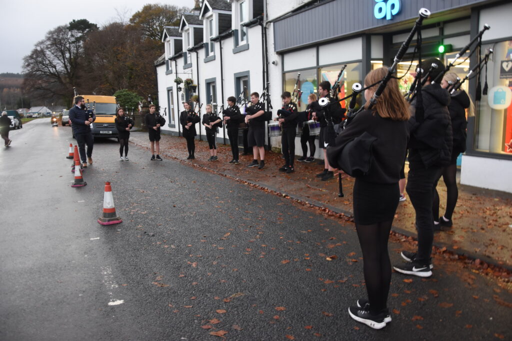 The Isle of Arran Music School Pipe Band performing outside Lamlash Co-op last Friday.