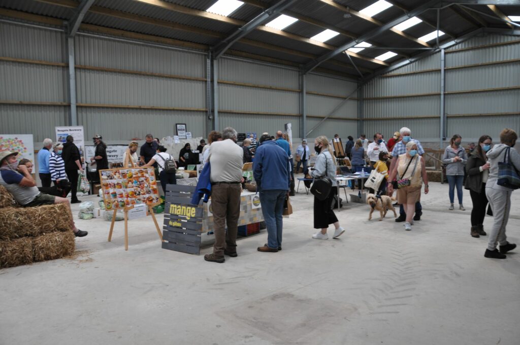 Visitors browse some of the various stalls at the first Farmers Market.