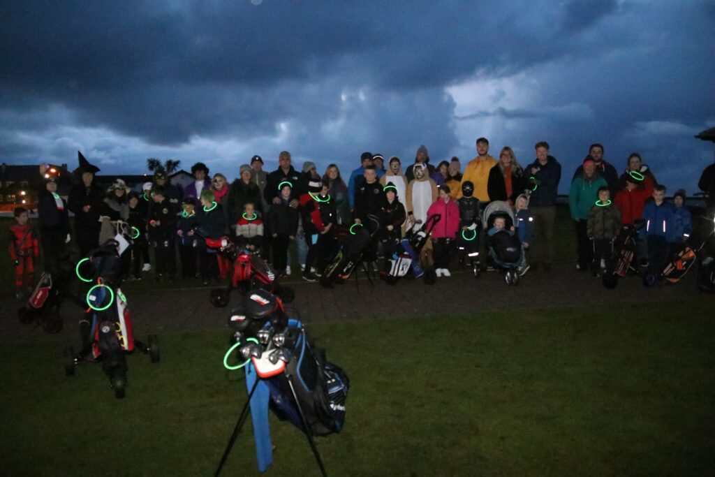 Junior golfers donned glow-in-the-dark clothing for their nighttime Hallowe'en competition.