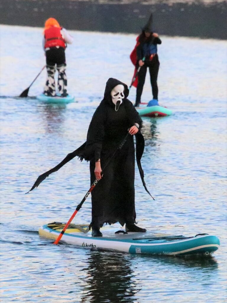 This paddleboarder sporting a scream mask cuts an eerie figure as they glide across Campbeltown Loch.