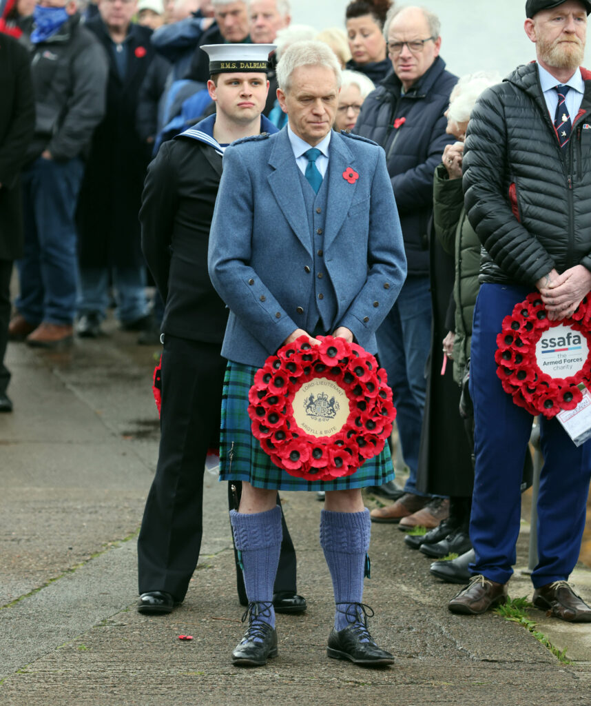 Deputy Lord Lieutenant Neil Matheson waits to lay a wreath at Oban's war memorial on the esplanade