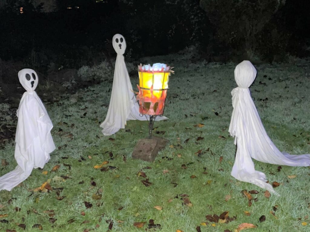 These ghostly ghouls appear to float around a glowing fire pit.
