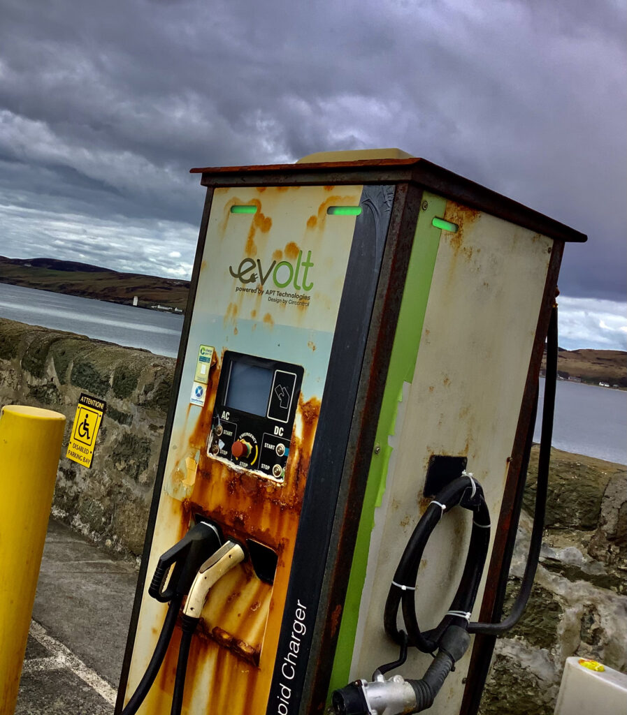 Caillin Swanson's image depicts a rusting electric car charger by the sea-wall.