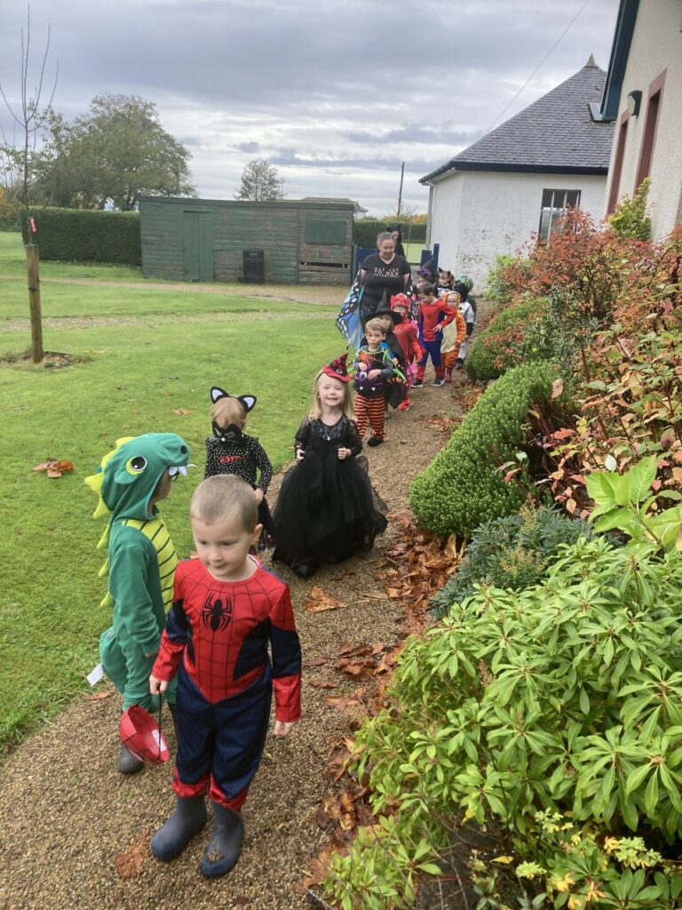 Brodick Early Years children parade around the garden in their Hallowe’en outfits.