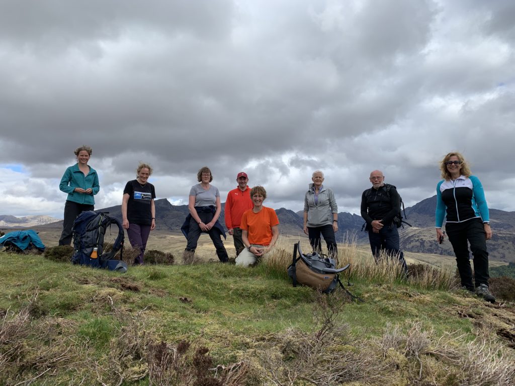 May: Walk leaders Jo Totty, centre, and Franny Schlicke, far left, take a well-earned rest at the top of Windmill Hill during a 17km guided walk during the Arran Mountain Festival.