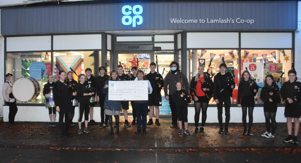 November – Players in the Arran Music School Pipe Band were celebrating a kind donation from the Co-op community fund which will be used to help buy new uniforms.