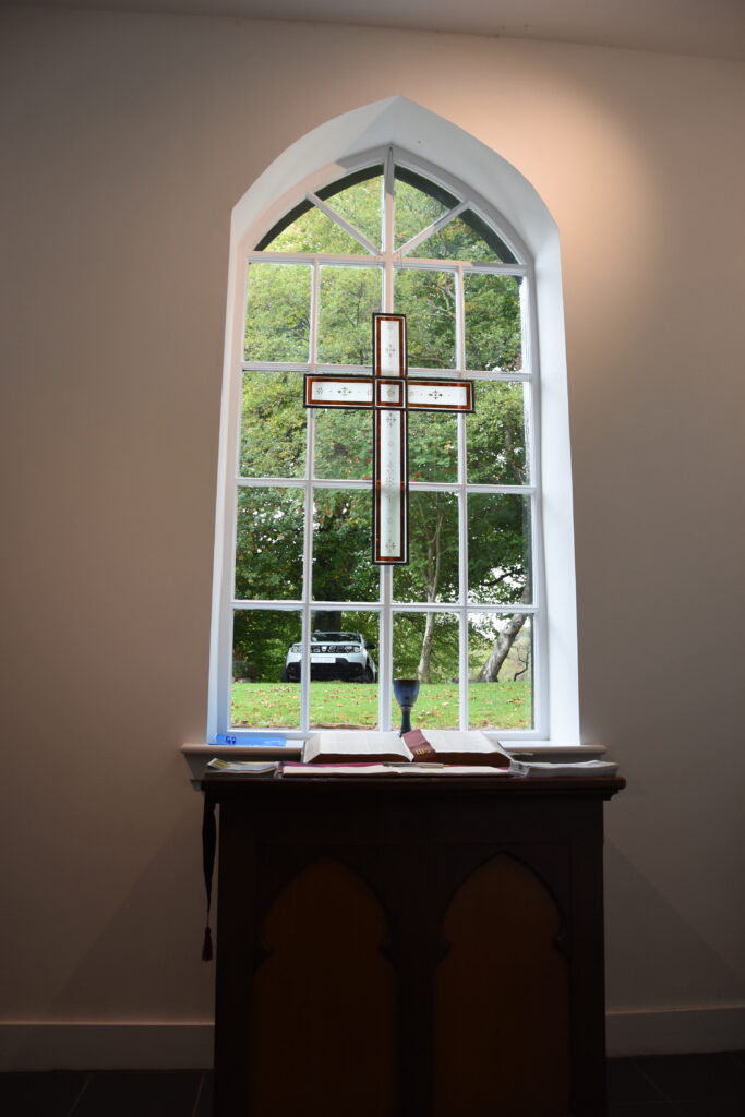 A stained glass cross in the church vestibule.