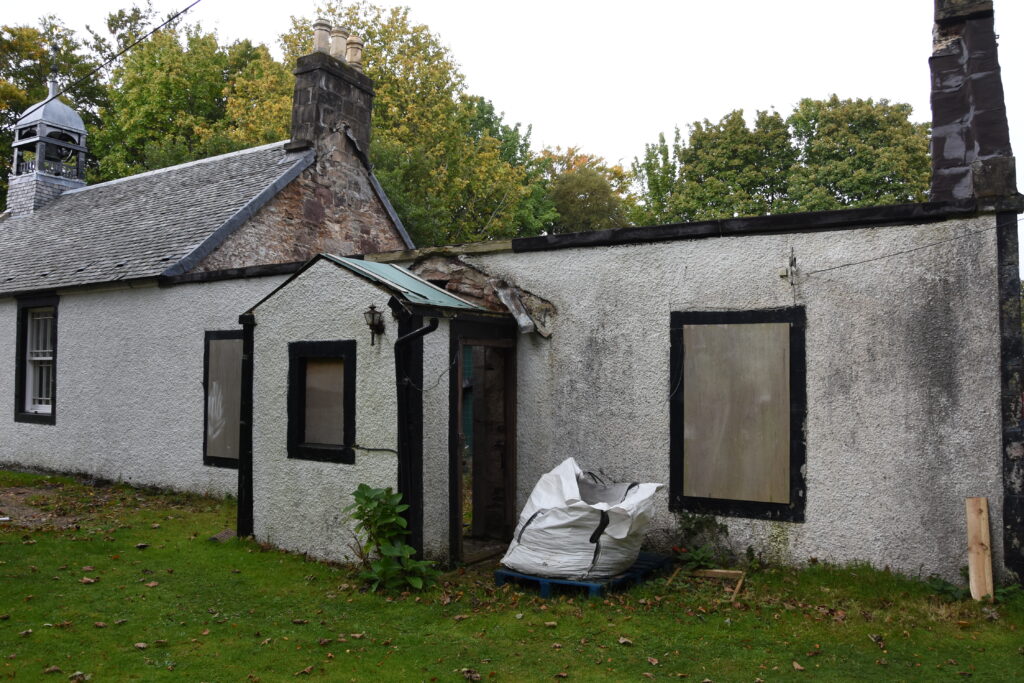 An exterior view of the derelict manse building.