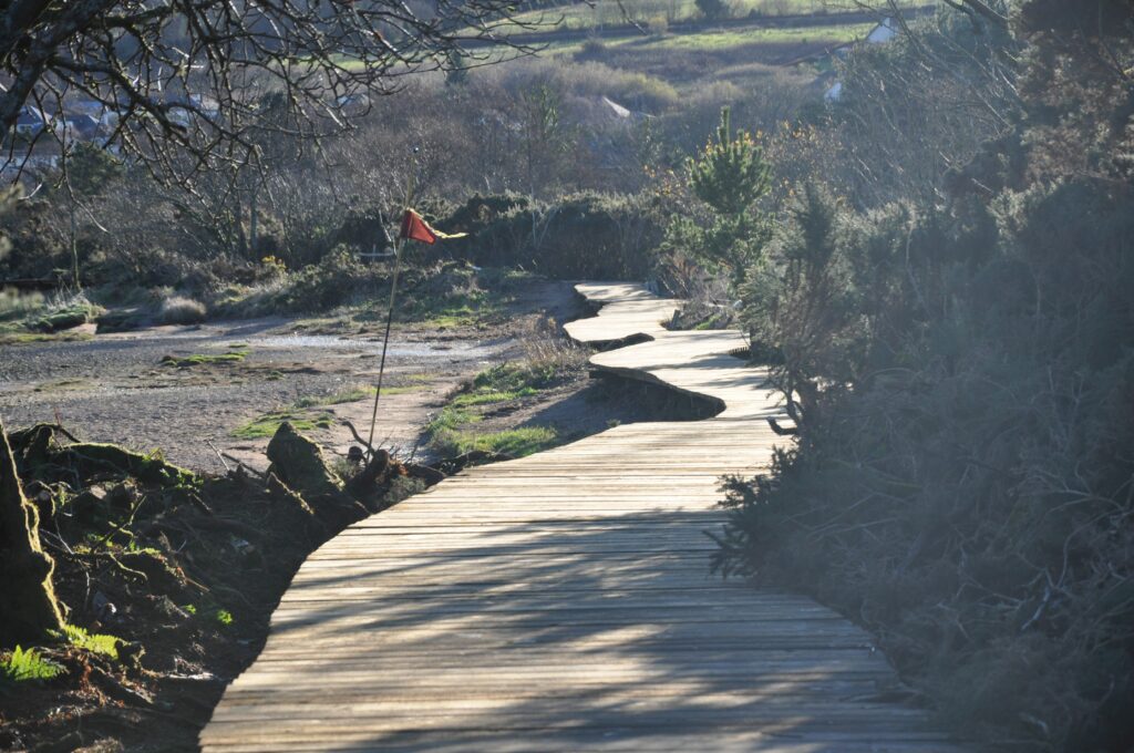 The walkway sits above the previous path and winds along the contour of the golf course embankment.