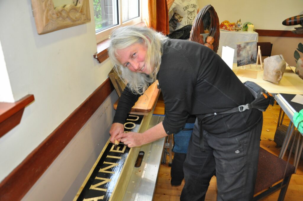 Signmaker and artist Zabdi Keen demonstrates the precision required for a large commission that she is working on.
