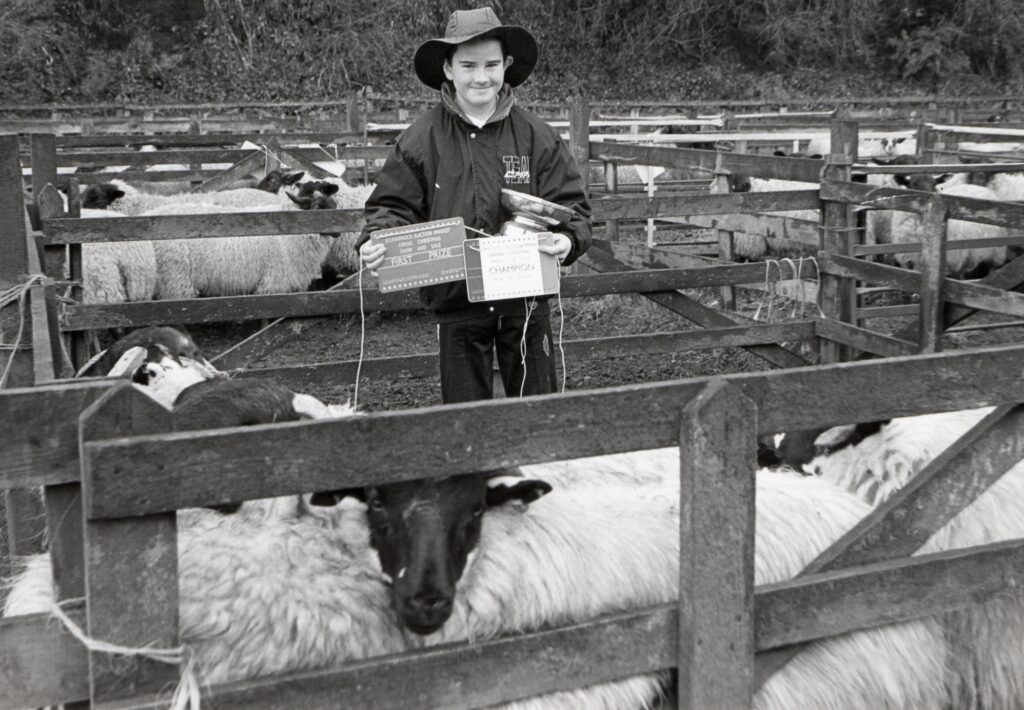 1990, eleven-year-old Adam McEacern with his pen of five champion Blackface lambs.