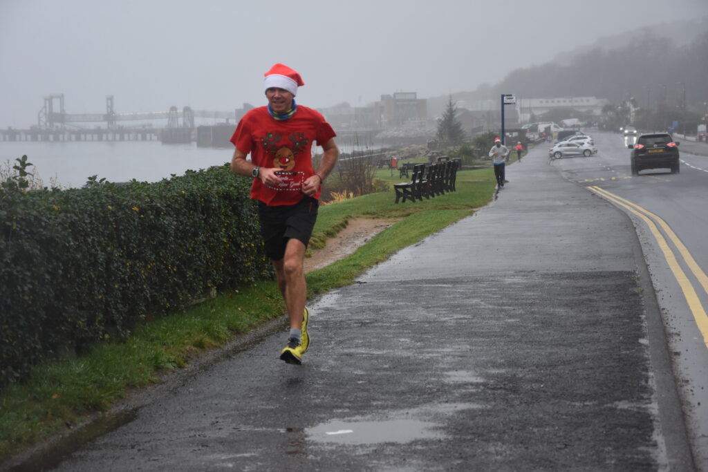Mark Berry, the first runner to cross the finishing line, makes his way along Brodick shorefront.