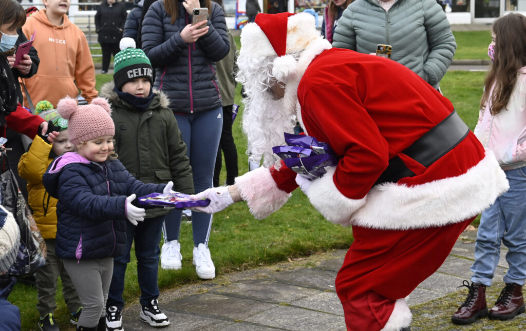 Children flocked to meet the man in red when he stopped off at Caol Shopping Centre to hand out gifts. Photograph: Iain Ferguson, alba.photos

NO F52 SANTA IN CAOL 03