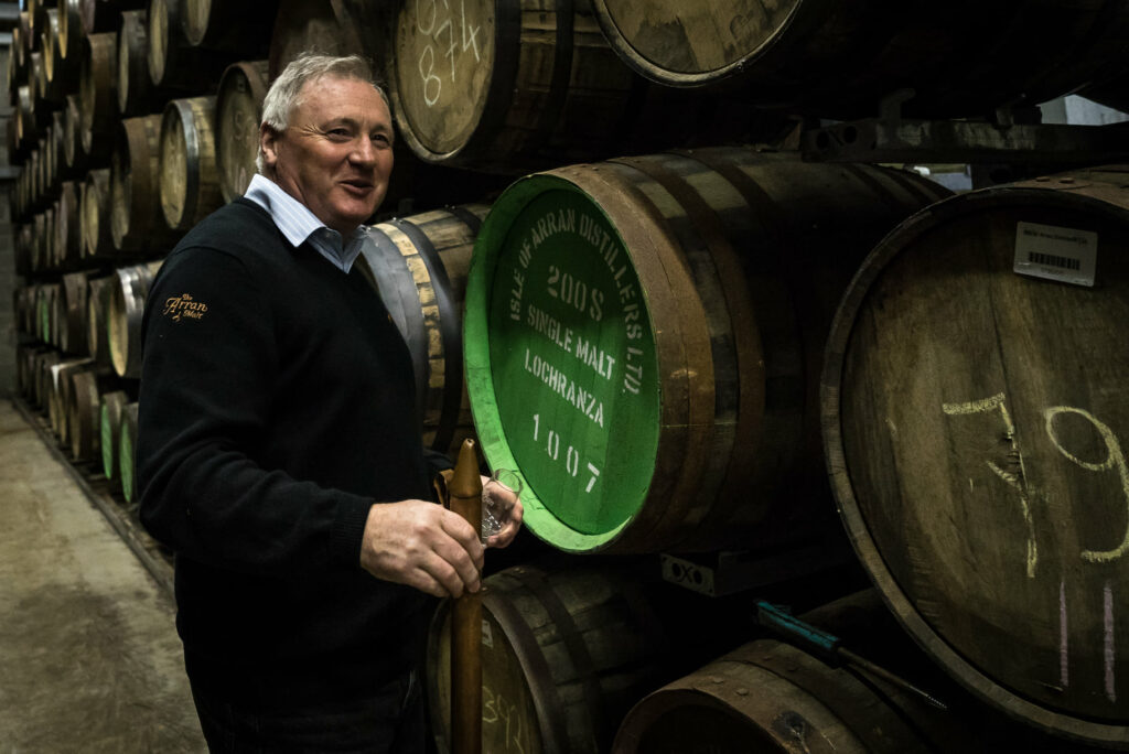 James tests the whisky in the warehouse at Lochranza distillery.