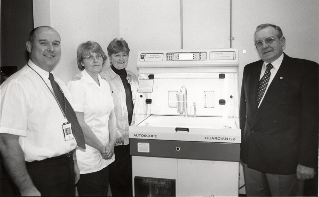 Jim Henderson, on behalf of ArCaS, right, presents a new washer/disinfector to Arran War Memorial Hospital. On the left is Alan Stout with nurses Esther Henderson and Charlotte Weir who operate it.