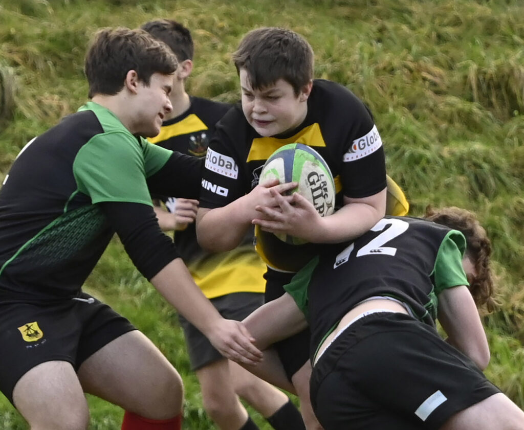 Lochaber's Cody MacKay makes a powerful drive against an Oban tackle.   Photograph: Iain Ferguson, alba.photos

NO F03 Rugby Loch Oban U16 02