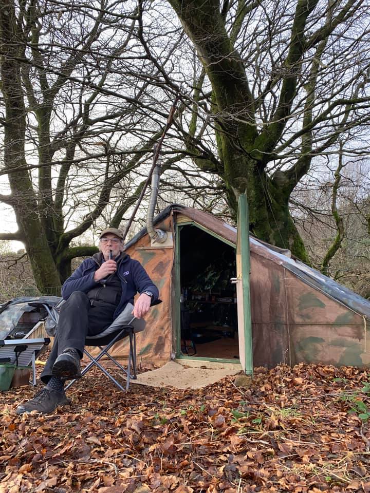 Jim is pictured outside his warm and comfortable canvas and wood tent.