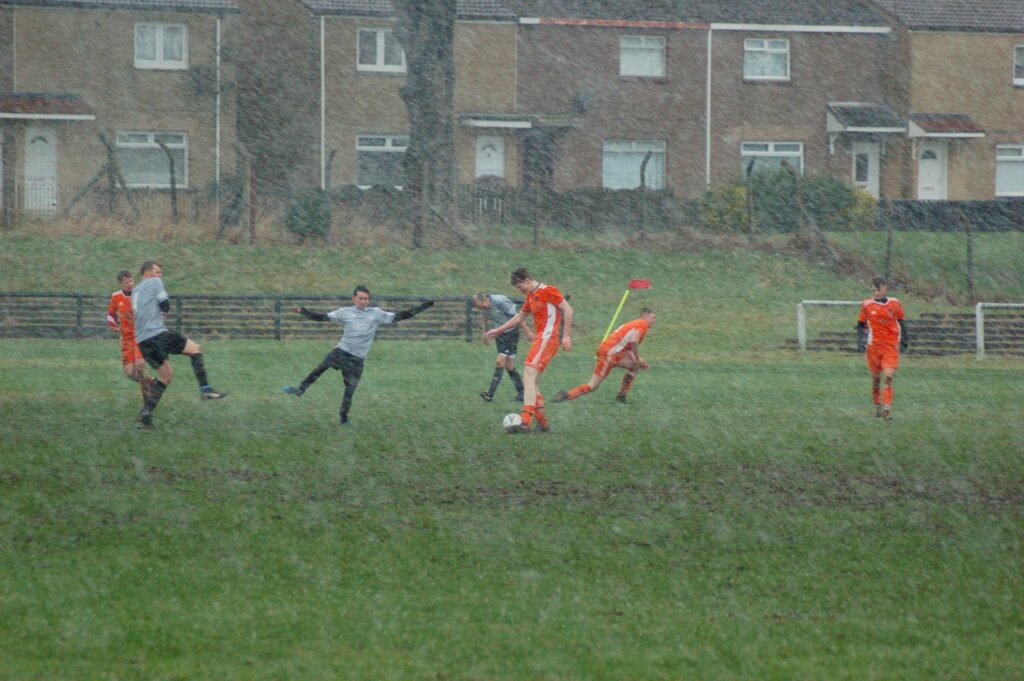 The two teams continued to play despite heavy downpours which made conditions slippery underfoot.