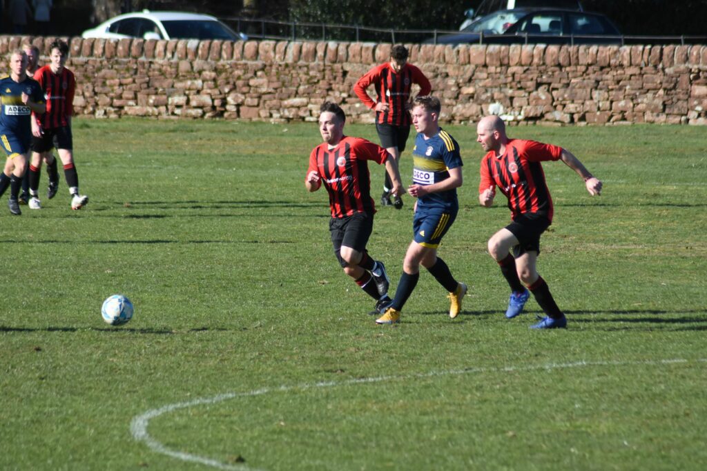 Arran players Christopher McNeil and Frazer Barr outflank the opposition to claim possession of the ball.