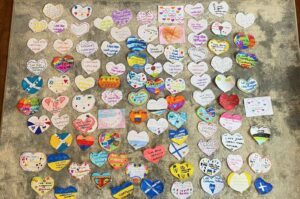 Children from Dalintober and Castlehill primary schools have made hearts reading, 'Love from Campbeltown, Scotland,' which will be put in the pockets of clothes for refugees.