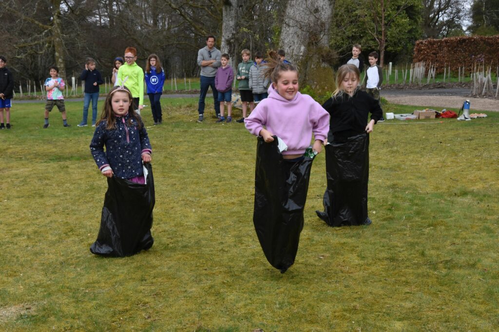 Young girls compete in the under six sack race.