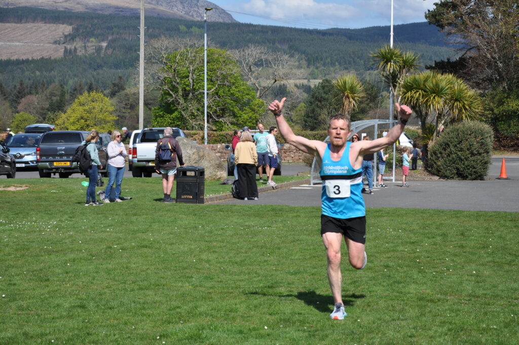 A jubilant David Allsop crosses the finishing line.