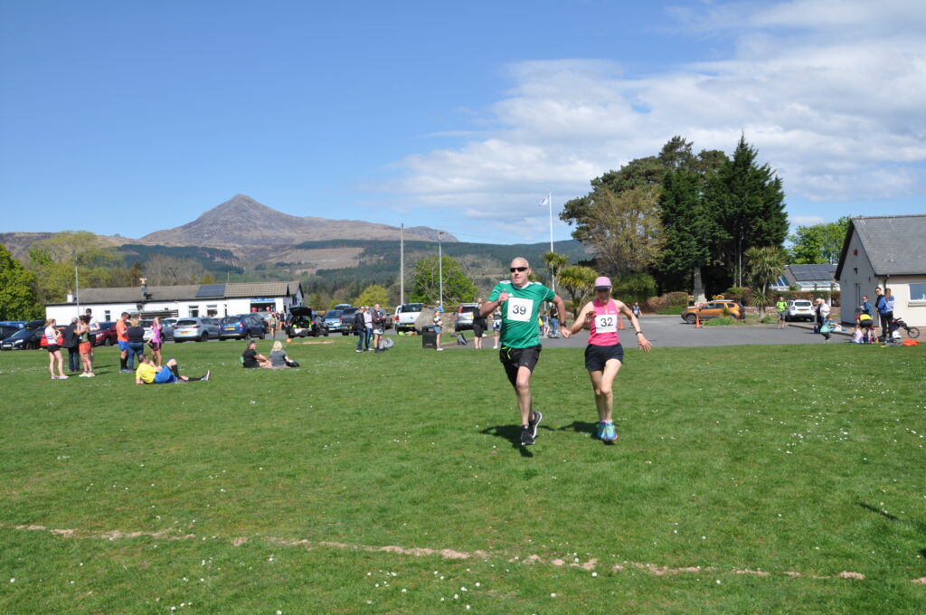 Two runners in a sprint for the finishing line.