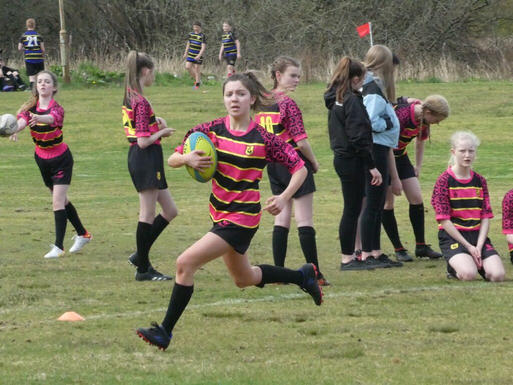Abby MacQueen running in for her second of 13 tries on the day.