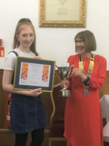 Emily Bennie receives her Young Musician of the Year 2021 Award from Rotary Club of Campbeltown president Pat Healey.
