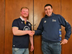 Jamie McLean, left, handing over the chairperson's reins to Fraser MacPhail.