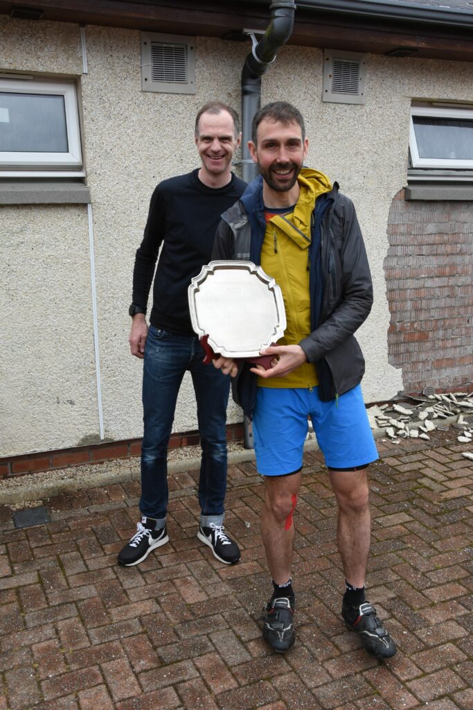 Finlay Wild receives the winners’ trophy from race organiser Peter Mackie.