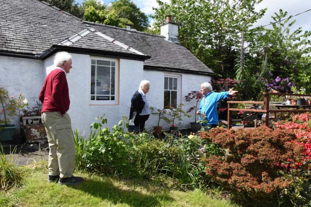Gordon Davidson shows visitors around his elevated garden in Corrie.