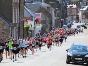Half marathon and 10K competitors making their way along Millknowe Road shortly after both races kicked off together on Sunday.