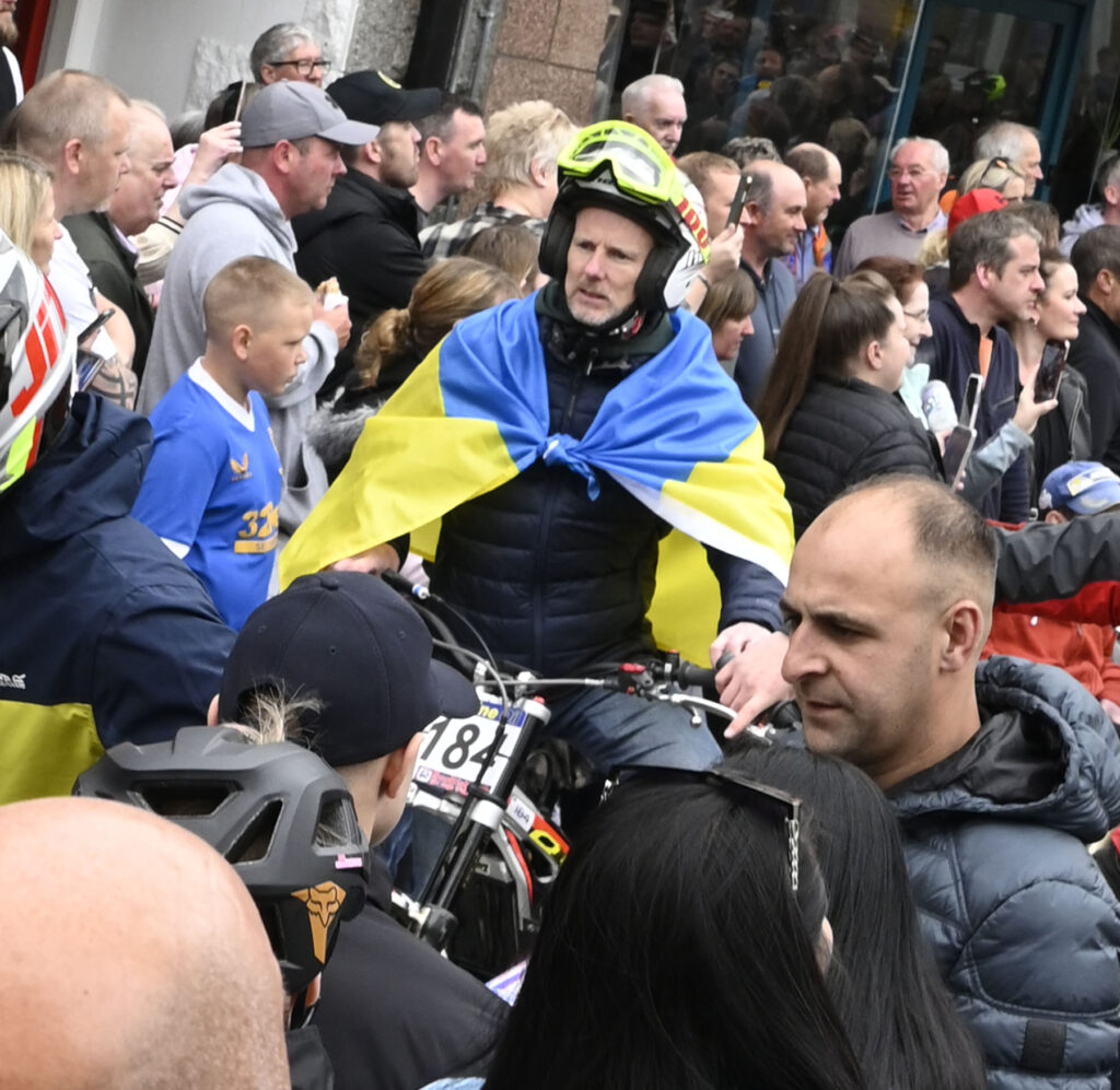Russell Houston from Knock in Ireland wore a Ukranian flag to show support for their struggles. Photograph:  Iain Ferguson. alba.photos