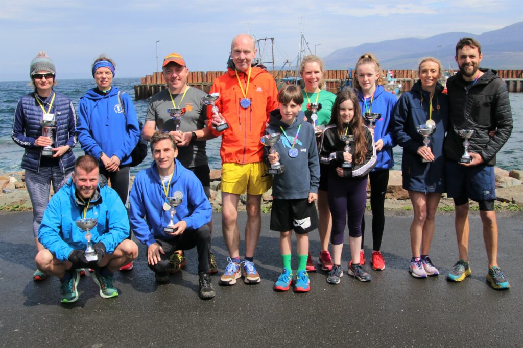 The trophy-winners after Sunday's Great Carradale Canter, with their times and races, standing, from left, are: Trudy Kennedy (33.47/5k), Jennifer Campbell (47.29/10k), Bryan Gregg (59.23/10k), Nicholas Gemmill (37.24/10K), Sorley Gemmill (30.01/5k), Lorraine MacPherson (34.35/5k), Cara MacPherson (34.34/5k), Niamh Quinn (28.00/5k), Emma Jessop (46.50/10k) and Tom Jessop (38.50/10k). Front, from left: Paul Clawson (40.33/10k) and Gordon Sandler (55.23/10k). Three trophy winners are missing from the photograph. The trophies were sponsored by Jewellery Casting Scotland.