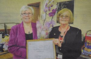 In 2012: Jan McNair, left, was presented her volunteer of the year award by manager of Campbeltown's Red Cross shop, Sheena Howarth.