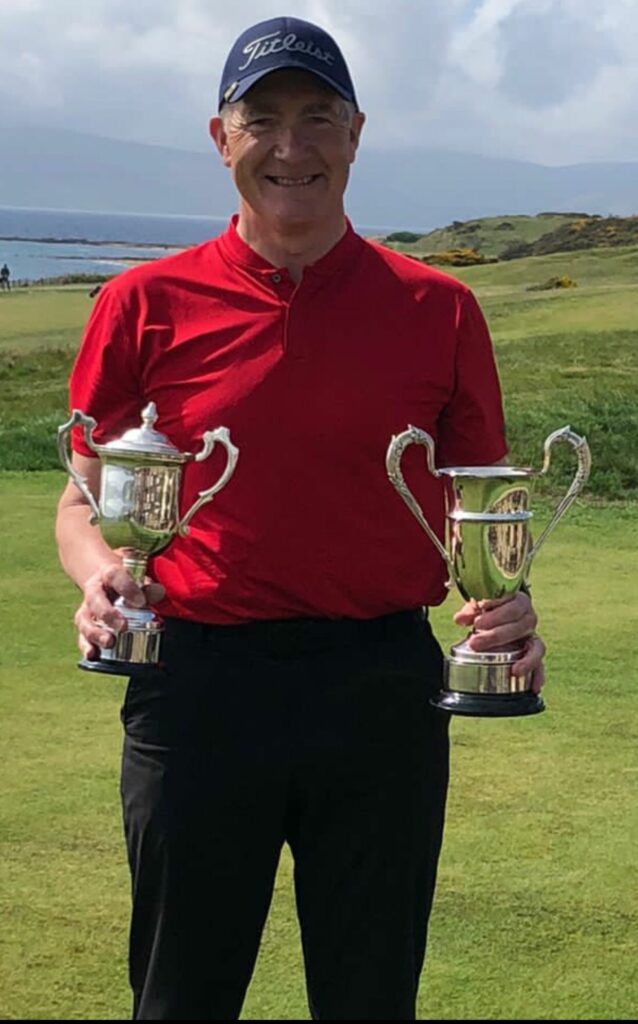 Shiskine’s Tony Ellis with his two trophies, the Winter Cup, which was bestowed to the Club by Willie Kelso, and the Daniel Ferguson Trophy, won with a gross 43, one over par, played from the back tees and in testing conditions.