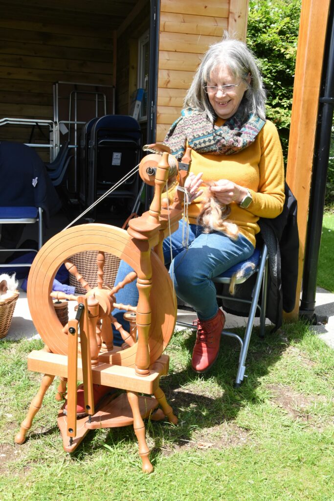Jan Grant spins a mixture of alpaca and mohair wool to create a soft wool which she uses to knit.