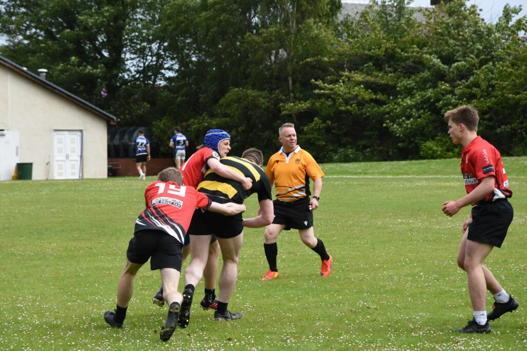 Arran players tackle a Southern Kites player trying to make his way to the try line.