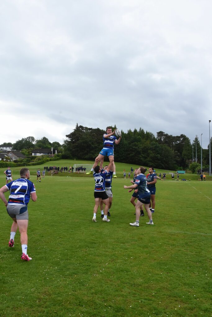 The Ruck Inspectors hoist their player into the air during a line-out with Glasgow Accies.