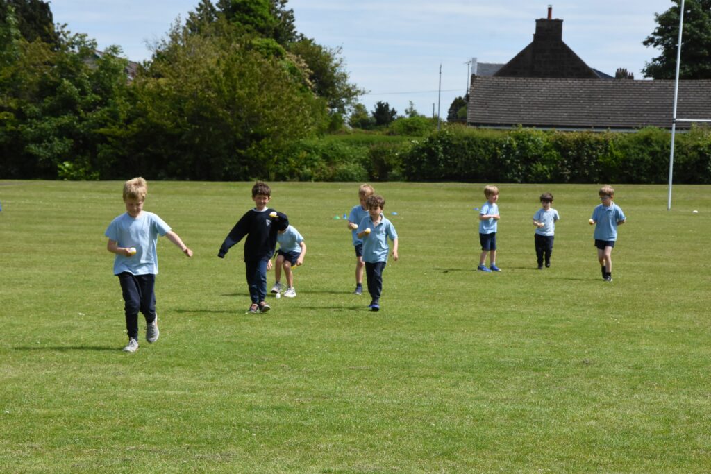 Children concentrate during the egg and spoon race.