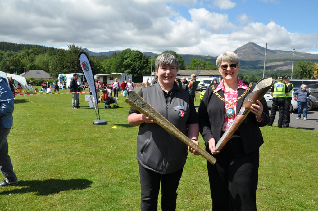 Carol Harwood brought her torch from the 2012 London Olympic games along to meet the Commonwealth Games baton.